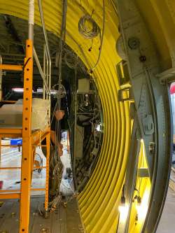 Relocating the door hydraulic system to behind the plug